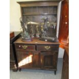 Small antique oak dresser with a boarded shelf back above two drawers and panelled doors (with