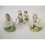 Pair of Sitzendorf porcelain figures of girls with crinoline dresses together with another of a boy