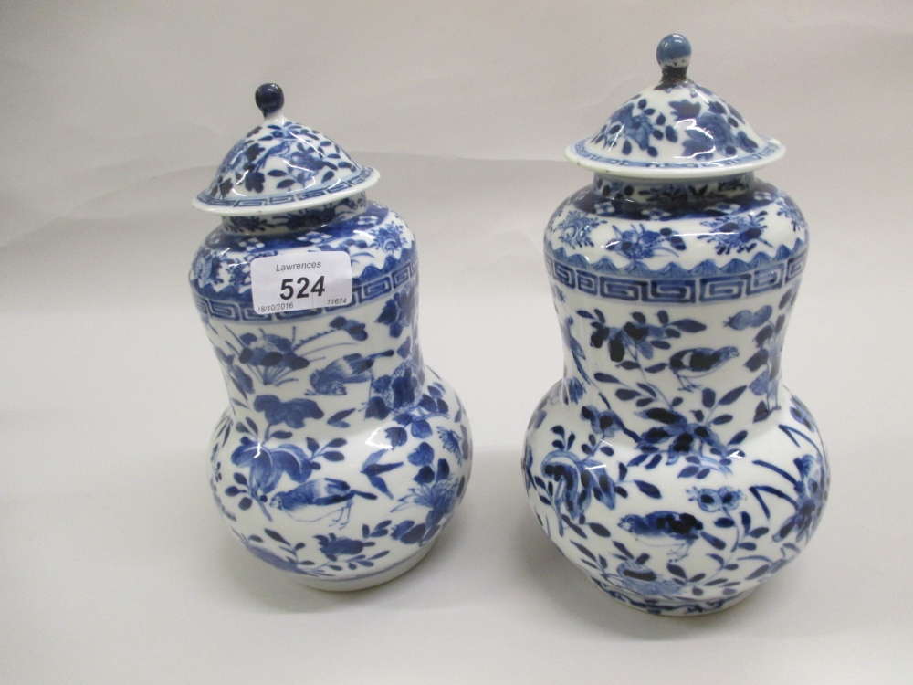 Pair of 19th Century Chinese blue and white vases with covers (a/f)