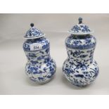 Pair of 19th Century Chinese blue and white vases with covers (a/f)
