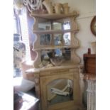19th Century beechwood corner unit having mirrored shelved back above a single arched mirrored door,