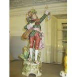 Large Royal Dux matt glazed figure of a standing boy holding a guitar with his arm aloft,