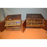 Two similar two door coin cabinets housing a collection of antique and later coinage