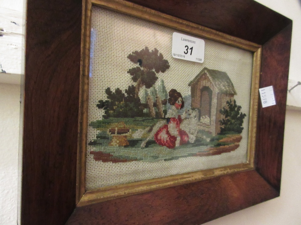 Small 19th Century needlepoint picture, girl with a dog before a kennel,