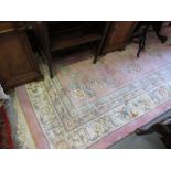 Chinese woollen carpet with floral decoration and multiple borders on a pink ground,