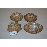 Three embossed silver trinket dishes and a similar Continental dish
