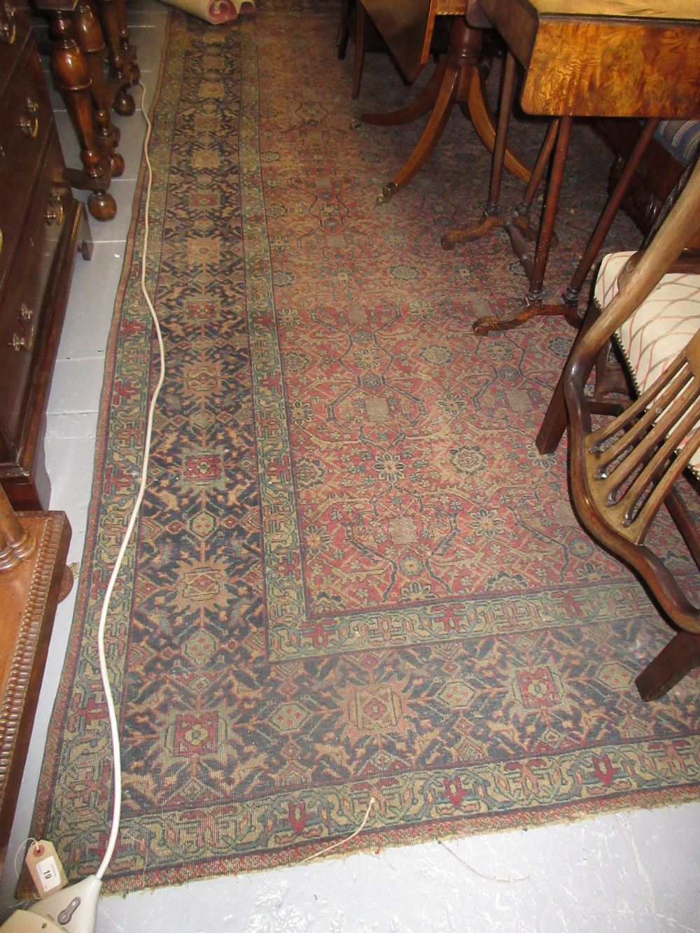 Large antique Feraghan rug having red and blue ground with all-over floral design and multiple