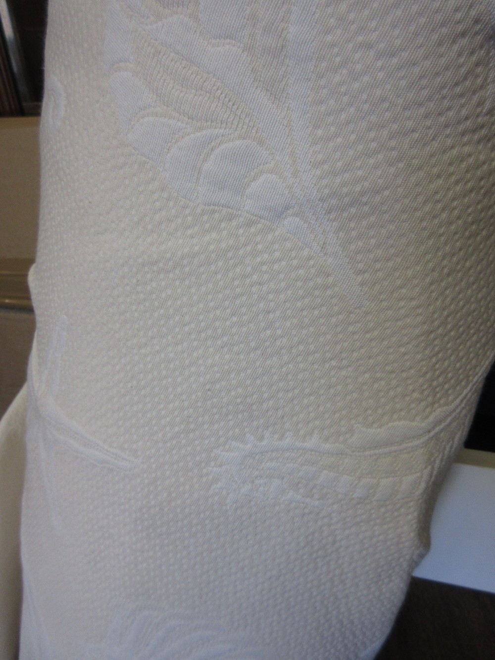 Large roll of shell motif cream fabric,