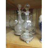 Group of three various glass decanters mounted on a plated stand together with a modern glass punch