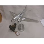 Modern polished metal model of an aeroplane and a metal pincushion in the form of a chicken (a/f)