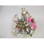 Continental porcelain figural group of figures playing backgammon at a table,