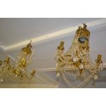 Pair of brass five branch chandeliers with cut glass drops,