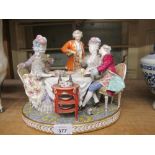 Large continental porcelain figural group of figures at a dining table,