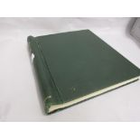 Green stamp album containing a collection of Q.E.