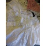 Two bags containing a quantity of 19th / 20th Century childrens and dolls clothes together with a