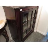 Regency mahogany single door side cabinet having bar glazed door enclosing shaped shelves on turned