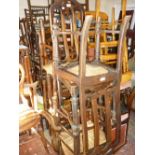 Harlequin set of six 18th / 19th Century elm ladder back dining chairs with rush seats together