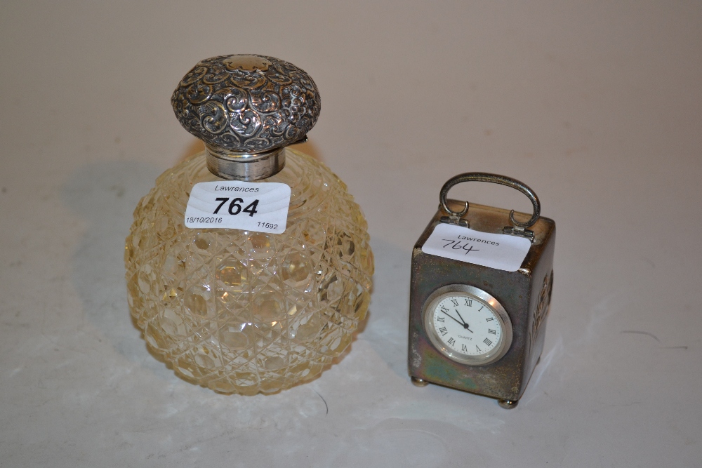 Silver mounted cut glass perfume bottle and a silver dressing table clock with replacement quartz