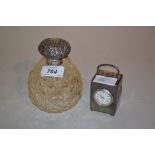 Silver mounted cut glass perfume bottle and a silver dressing table clock with replacement quartz