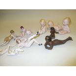 Collection of eleven various bisque figures of reclining nudes and babies