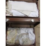 Three various suitcases containing a large quantity of various table linen etc.