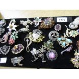 Quantity of various costume brooches mounted on a card