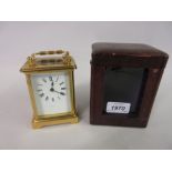 Small brass cased carriage clock with single train movement and original travel case