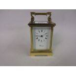 Gilt brass cased carriage clock, the enamel dial with Arabic and Roman numerals,