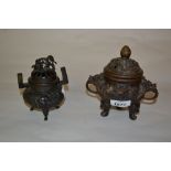 Chinese dark patinated bronze censer decorated in high relief together with another similar smaller