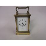 Small brass cased carriage clock, the enamel dial with Roman numerals, signed Oclee and Son,