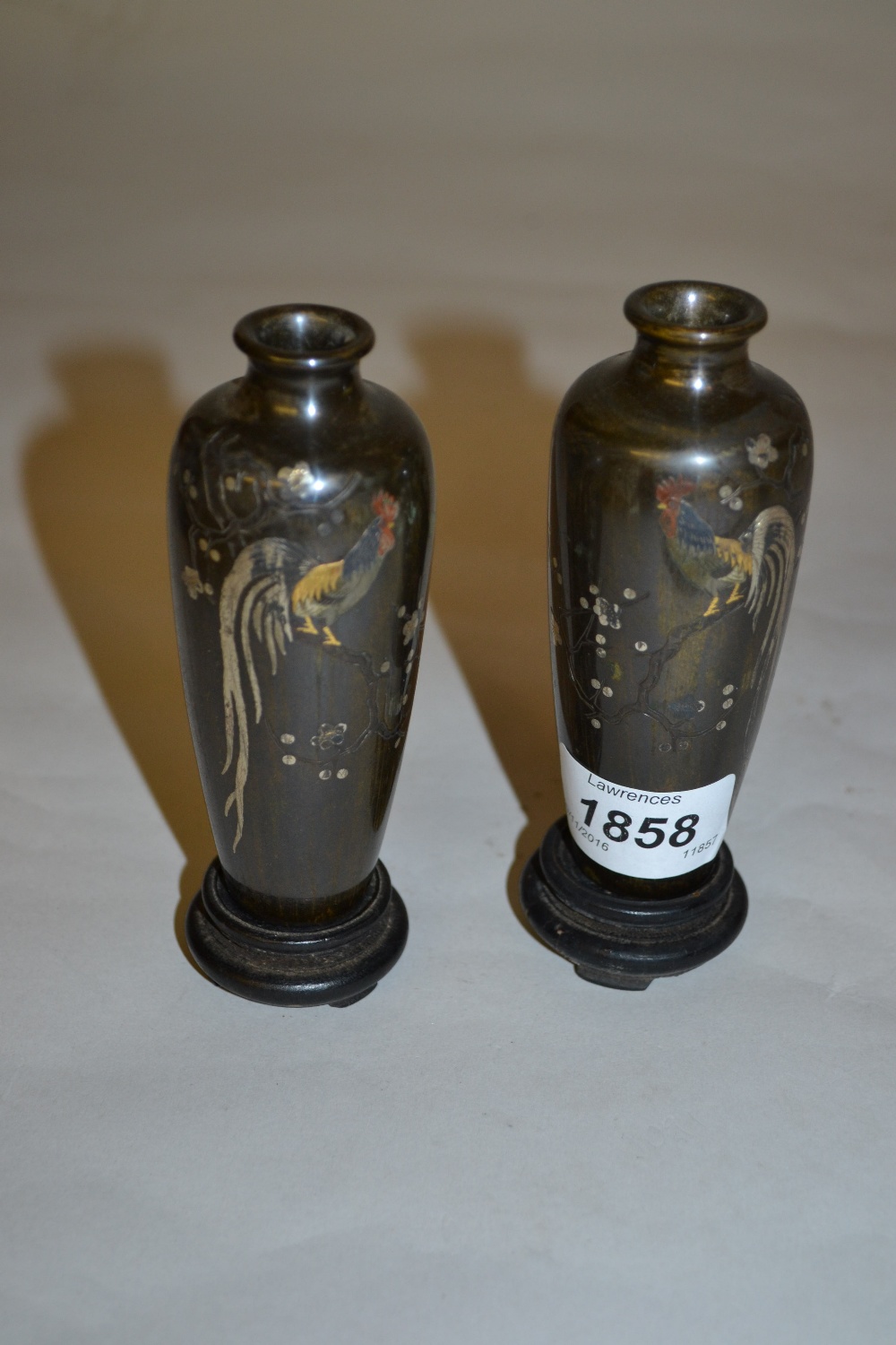 Pair of miniature Japanese bronze balaster form vases inlaid with precious metals with a design