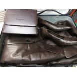 Suitcase containing a long leather coat by Ferragamo,