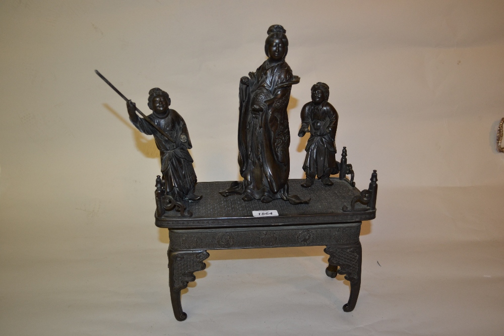 Late 19th Century Japanese dark patinated bronze group of three geishas standing on a table,