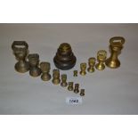 Two sets of brass bell form kitchen scale weights together with another set of kitchen weights