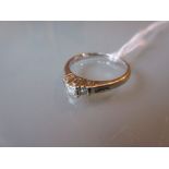 9ct White gold three stone diamond ring of Art Deco design with diamond set shoulders