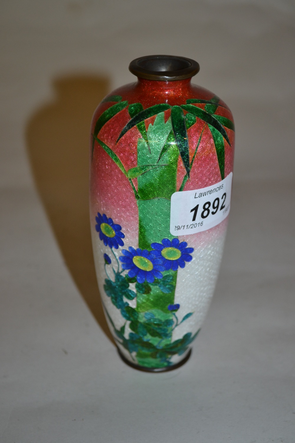 Small cloisonne baluster form vase with floral decoration on a foil ground