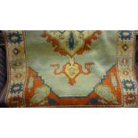 20th Century Turkish rug with medallion design on a pale blue ground (a/f)