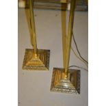 Pair of 20th Century cast brass standard lamps with reeded columns and cream upholstered shades