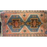 Small rug having geometric design with borders on a blue and red ground,