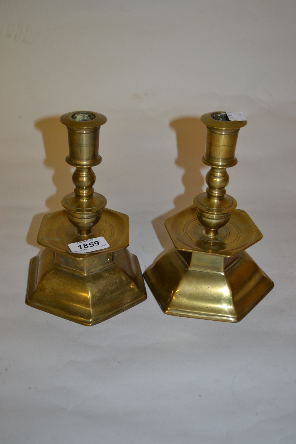 Pair of hexagonal brass candlesticks with drip trays