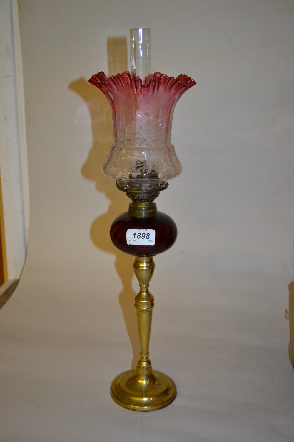 Small brass and ruby glass oil lamp with etched cranberry shade