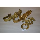 Two pairs of 19th Century brass curtain tie backs and a pair of 19th Century brass bell pull rings
