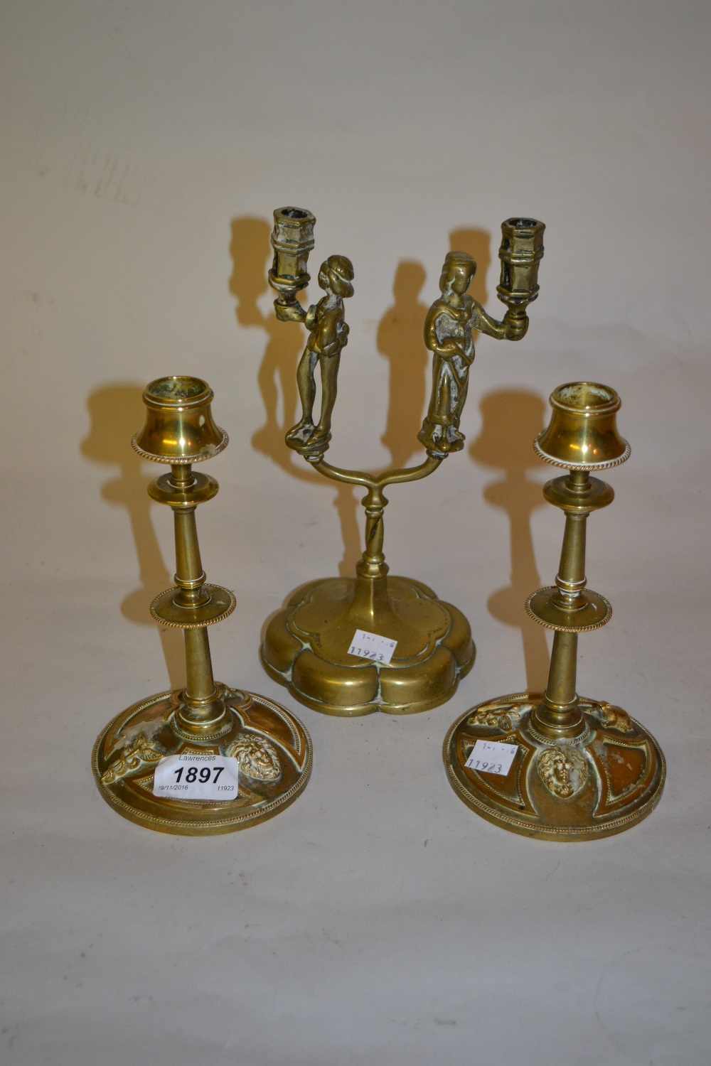 Pair of 19th Century French gilt brass candlesticks and a brass two branch figural candlestick