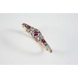 A VICTORIAN RUBY AND DIAMOND HALF HINGED BANGLE the three graduated oval-shaped rubies are set