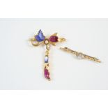 A SAPPHIRE AND RUBY BROOCH formed with carved rubies and sapphires, in gold, 4.5cm. wide, together