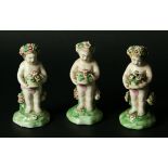 THREE DERBY 'PATCHMARK' PUTTI each holding a basket of flowers, incised marks to base, 10.5cm. (3).