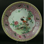 A CHINESE FAMILLE ROSE CHARGER, painted with a central peacock amongst flowers, inside an