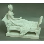 A SEVRES BISQUE PORCELAIN FIGURE, late 19th century, modelled as a maiden reclining on a couch,