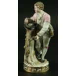 A MEISSEN FIGURE, late 19th century, model 122, of a young man standing by a tree trunk with a