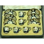 A ROYAL WORCESTER COFFEE SET decorated with gilt cartouches on a blue scale ground, printed and